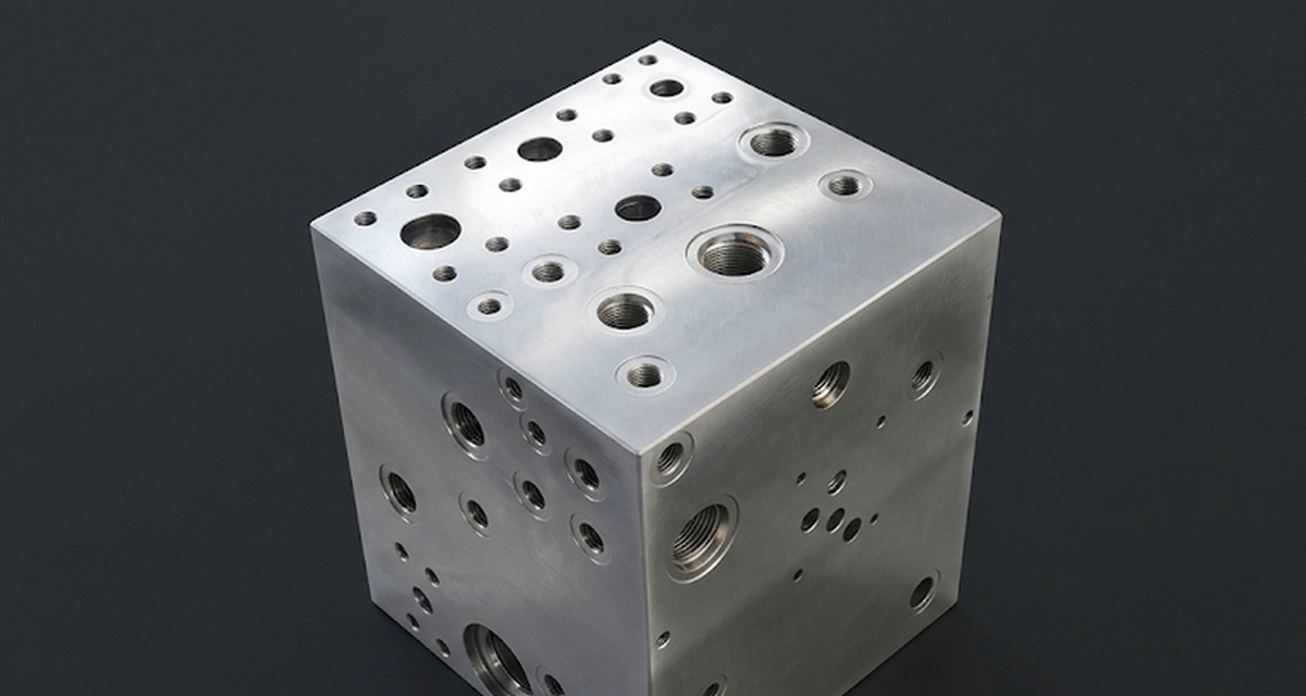 Stainless hydraulic manifold cube with mixed-diameter precision holes on three faces