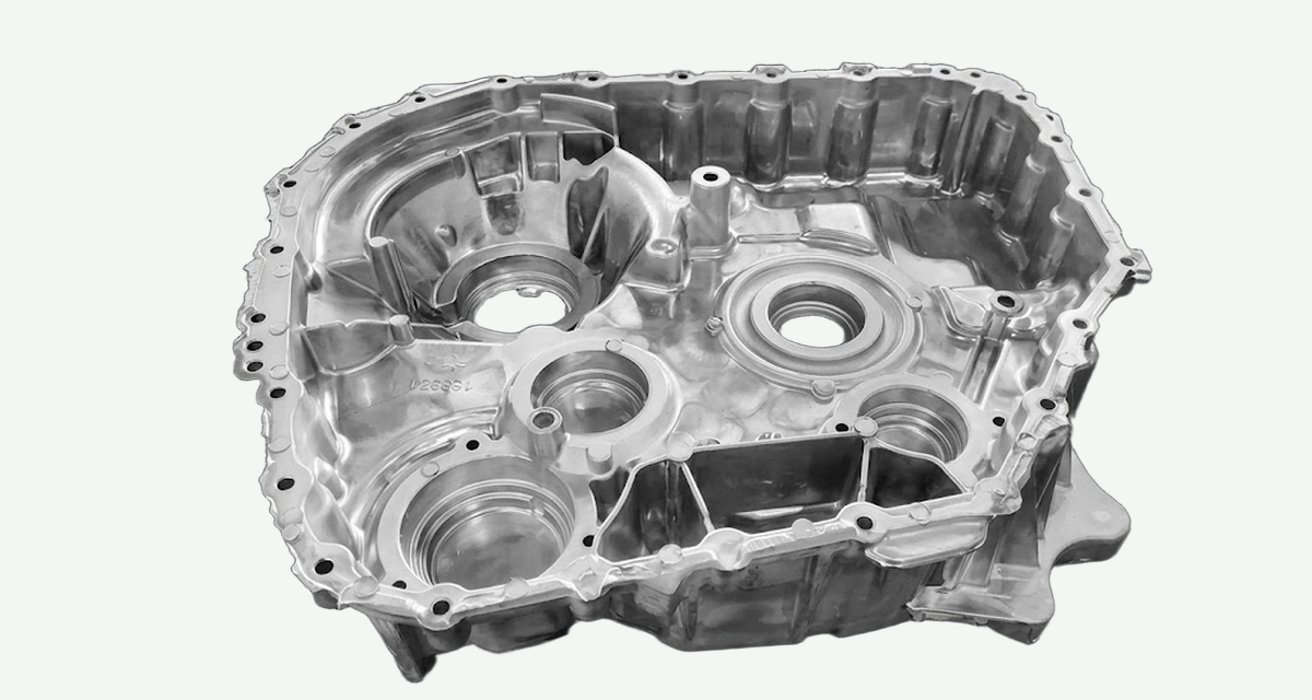 Open-top aluminum automotive transmission housing with machined bores and a flange bolt circle
